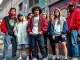 Streetwear clothes displayed by urban youth in a lively city scene.
